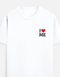A white short-sleeve crewneck t-shirt featuring a small graphic on the left chest that reads 'I' followed by a red heart and ' I LOVE ME' in black block letters by TREND FEVER