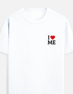 A white short-sleeve crewneck t-shirt featuring a small graphic on the left chest that reads 'I' followed by a red heart and ' I LOVE ME' in black block letters by TREND FEVER