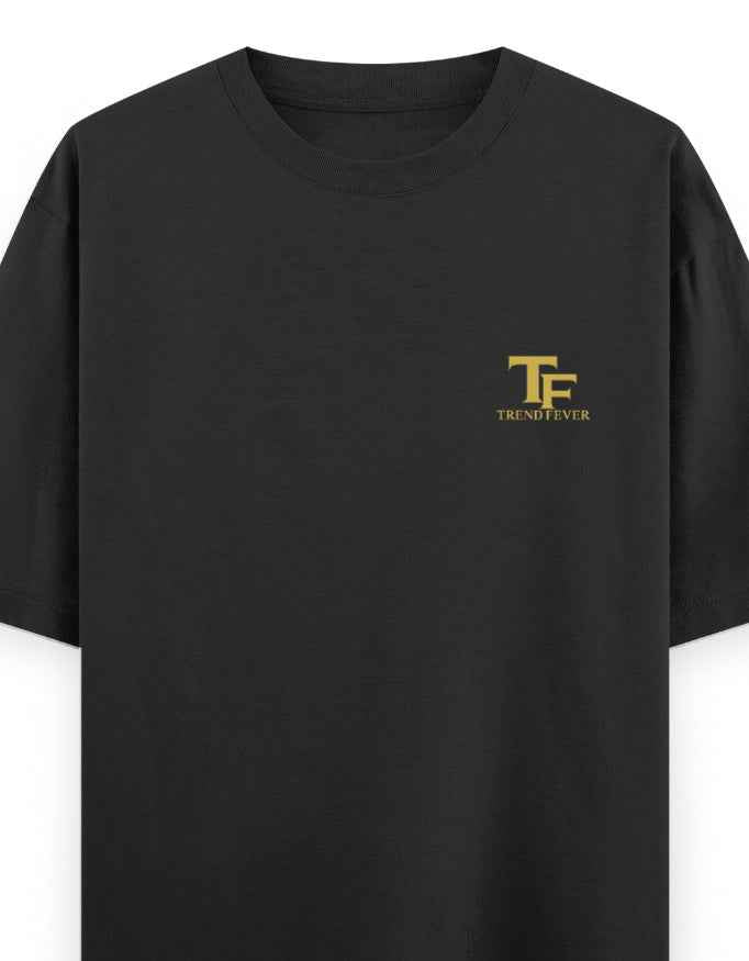 Black oversized t-shirt with small gold TF logo on left chest, streetwear style
