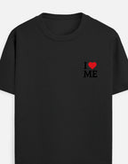 A BLACK short-sleeve crewneck t-shirt featuring a small graphic on the left chest that reads 'I' followed by a red heart and ' I LOVE ME' in black block letters by TREND FEVER