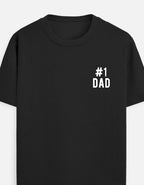 A white short-sleeve crewneck t-shirt featuring a small black outline graphic on the left chest that reads '#1 DAD' by TREND FEVER 