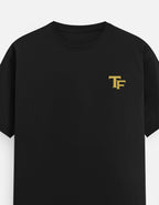 Navy blue t-shirt with a small white logo on a light gray background