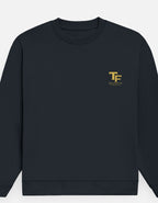 A Navy Blue crewneck sweatshirt with a small gold 'TF' logo and 'Trend Fever' printed on the left chest, displayed against a light gray background.