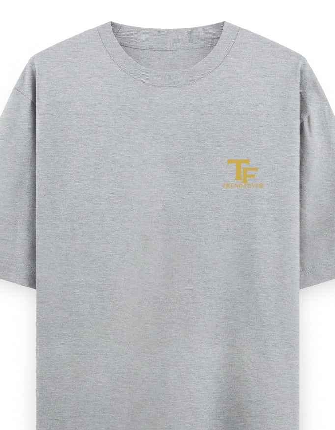 Light grey oversized t-shirt with small yellow TF logo on left chest