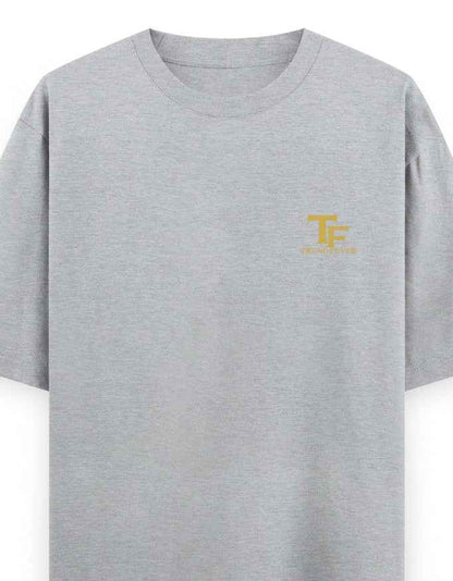 Light grey oversized t-shirt with small yellow TF logo on left chest