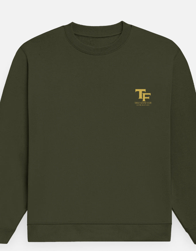 An olive green crewneck sweatshirt with a small gold 'TF ' logo on the left chest, displayed against a light gray background.