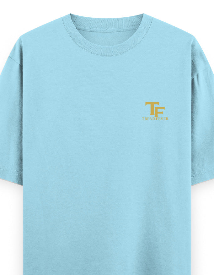 Light blue oversized t-shirt with yellow TF logo and short sleeves, minimalist streetwear