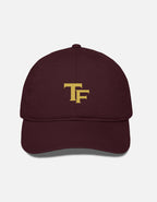 A black baseball cap with a gold embroidered 'Trend Fever' logo on the front, displayed against a light gray background.