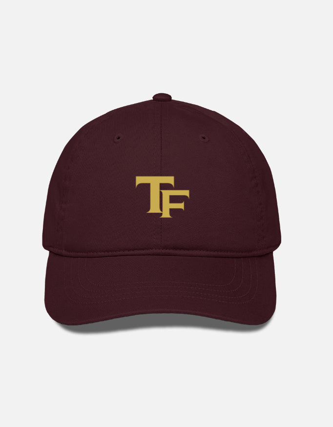 A black baseball cap with a gold embroidered 'Trend Fever' logo on the front, displayed against a light gray background.