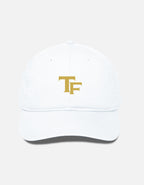 A white baseball cap with a gold embroidered 'TF - Trend Fever' logo on the front, shown against a light gray background.