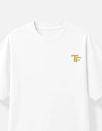 A white short-sleeve crewneck T-shirt featuring a small gold 'TF' monogram Trend Fever logo on the left chest, displayed against a clean white background.