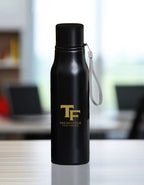 Trend Fever 750 ml black stainless steel water bottle with laser engraved logo, leak-proof insulated design for gym, office, travel, and everyday use.